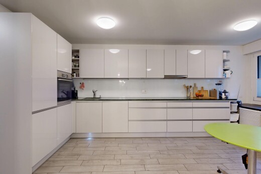 kitchen with open shelves, decorative backsplash, and white cabinets