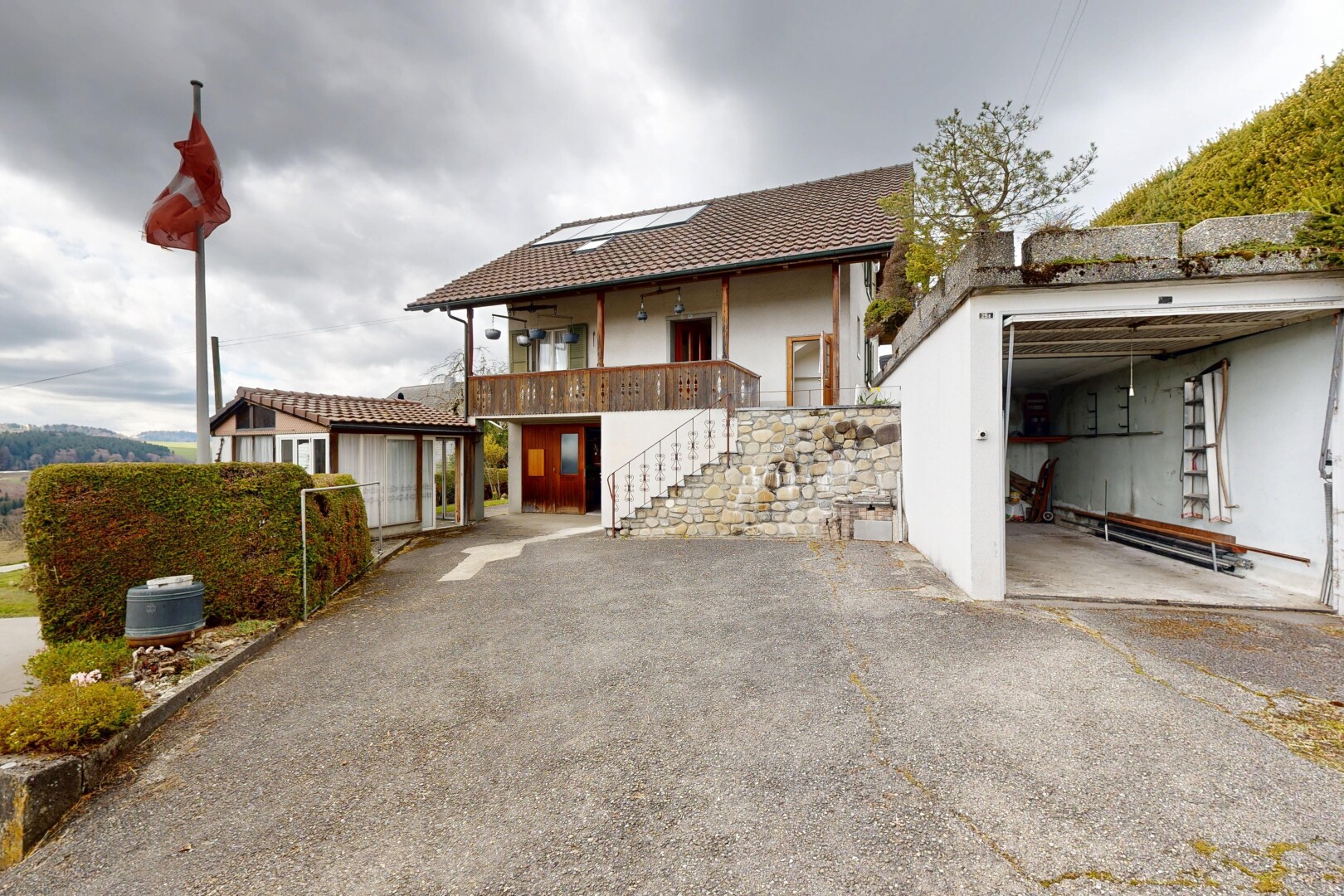 view of property featuring a balcony, a patio area, and stucco siding