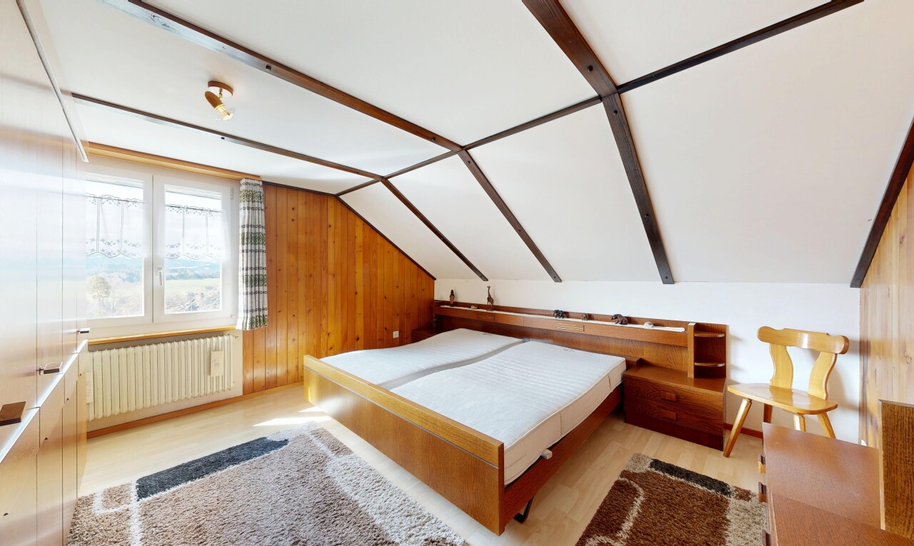 room featuring radiator heating unit, wood walls, light wood finished floors, and lofted ceiling