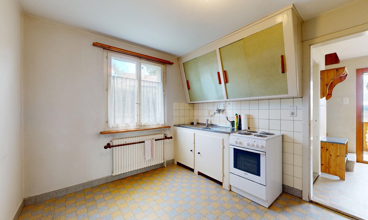 kitchen with white cabinetry, electric range, radiator, light flooring, and tasteful backsplash