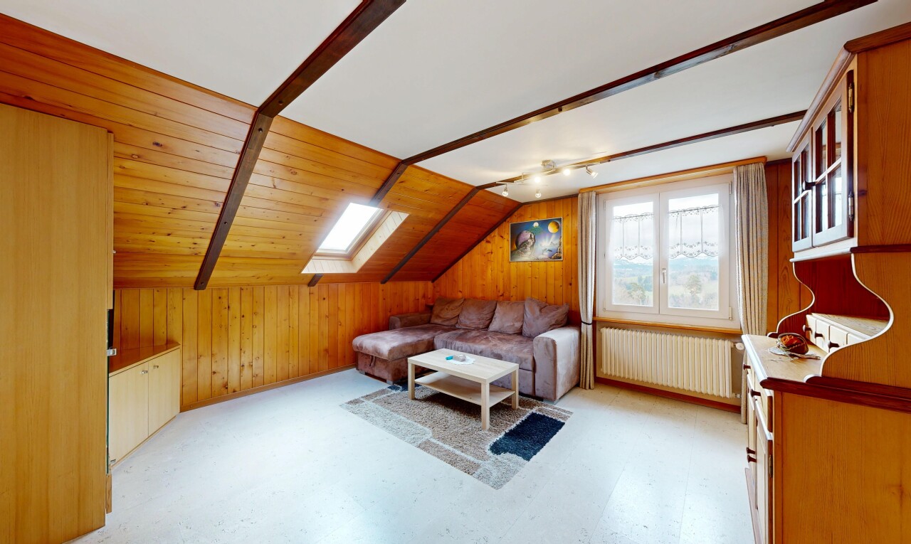 living room featuring radiator, vaulted ceiling, wooden walls, a skylight, and light floors