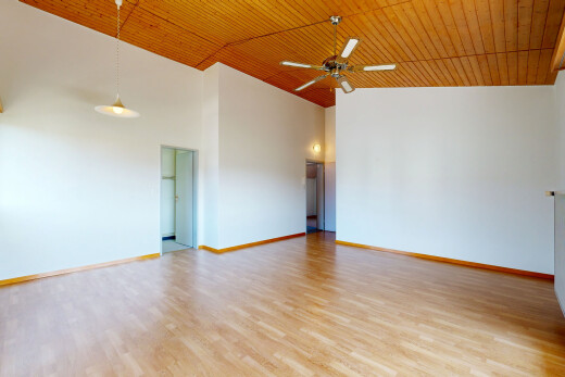 empty room featuring a vaulted wood ceiling, pendant lighting, ceiling fan, and light wood-style floors