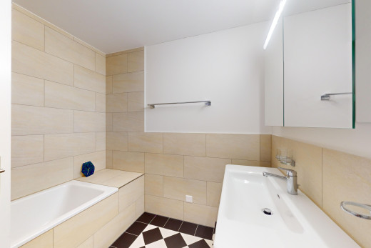 full bath featuring a garden tub, tile walls, and vanity