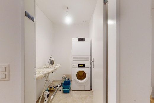 laundry area featuring stacked washer / dryer