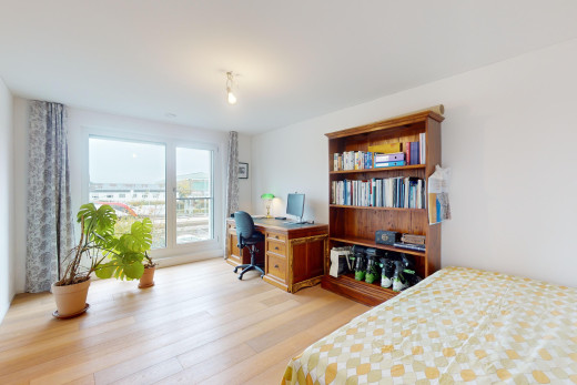 room / bedroom featuring light wood-type flooring and an office area
