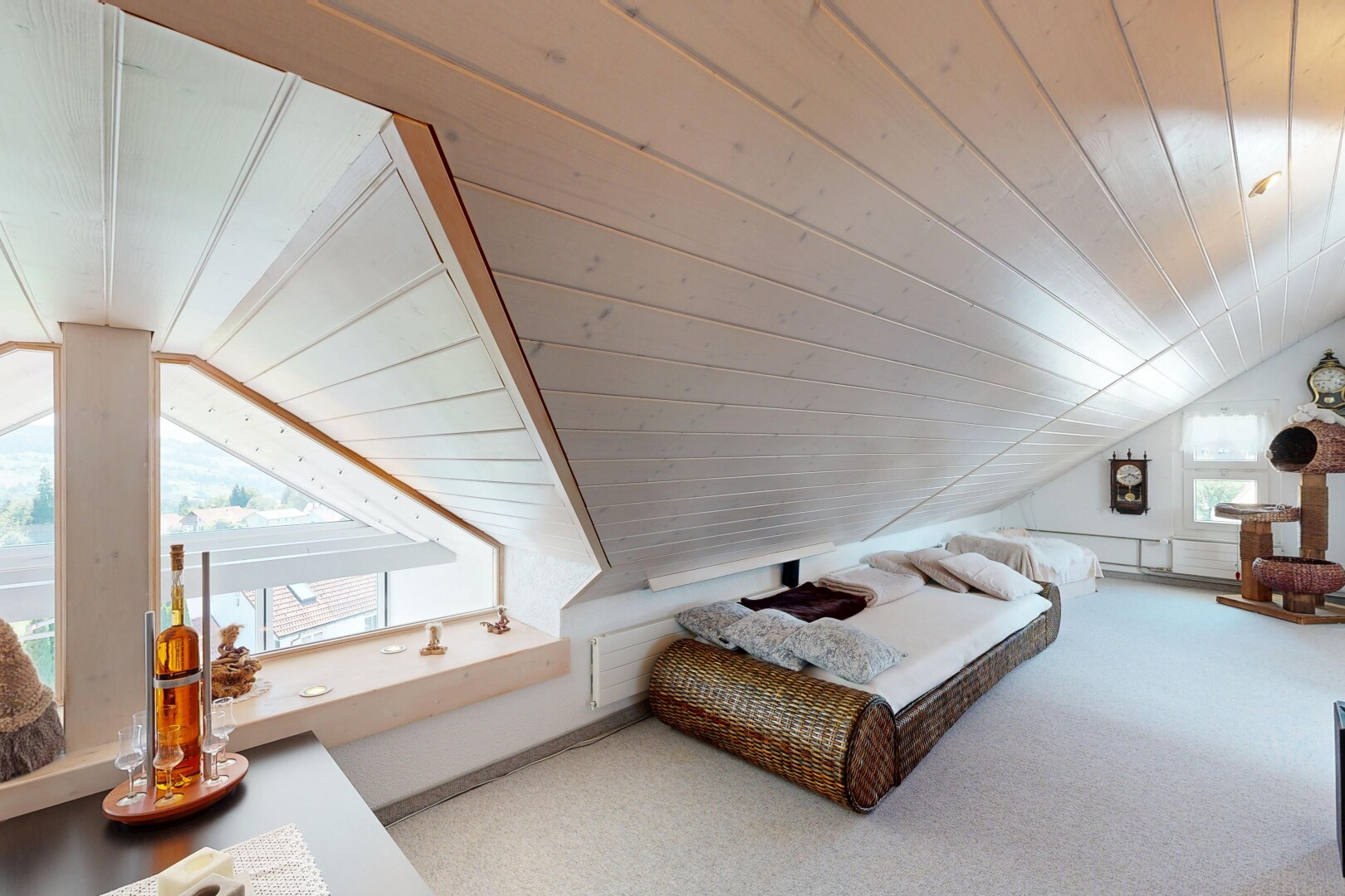 room with a vaulted wooden ceiling and carpet floors
