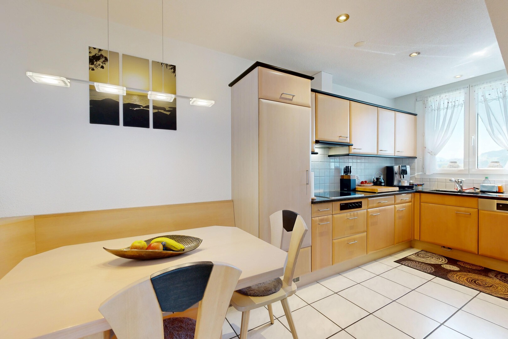 kitchen featuring dark countertops, recessed lighting, light tile patterned floors, backsplash, and light wood finish cabinets