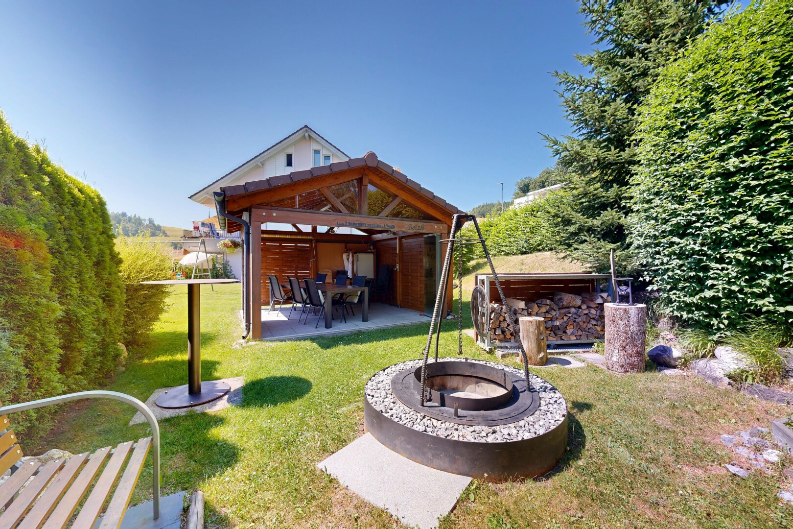 outdoor house with a patio area, an outdoor fire pit, and a yard
