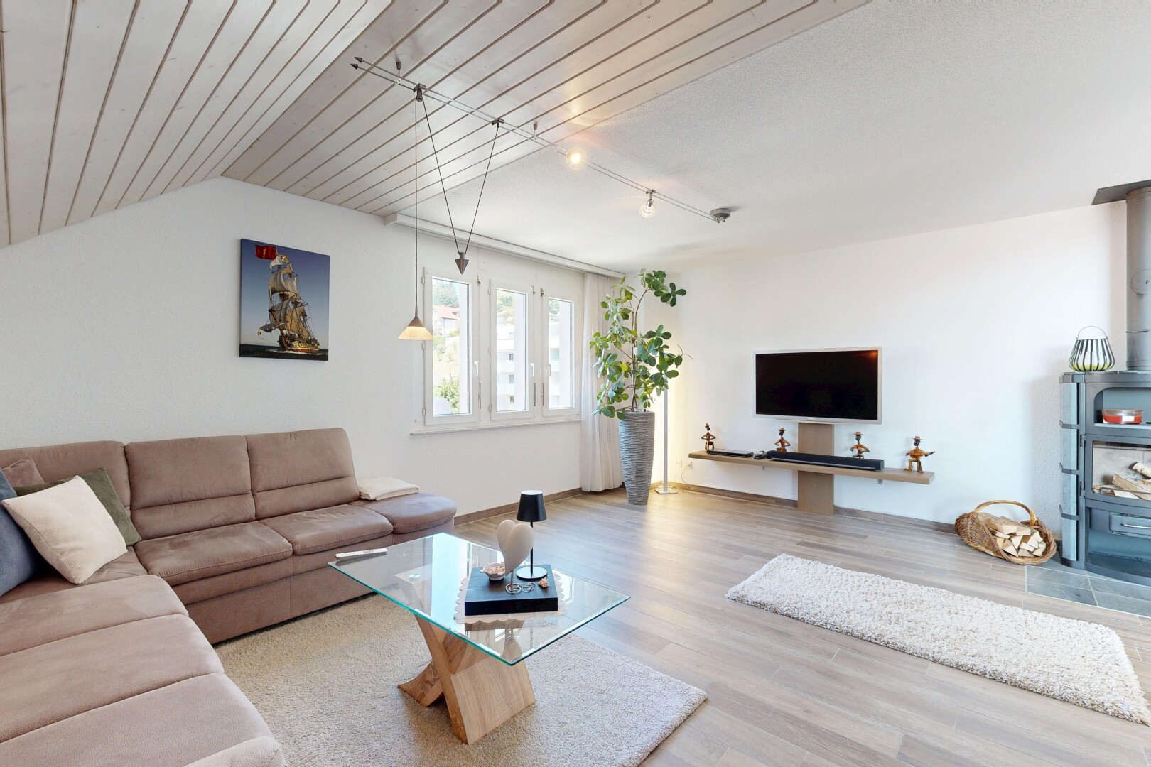 living room with rail lighting and light wood finished floors