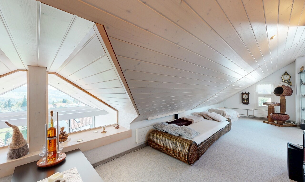 room with a vaulted wooden ceiling and carpet floors