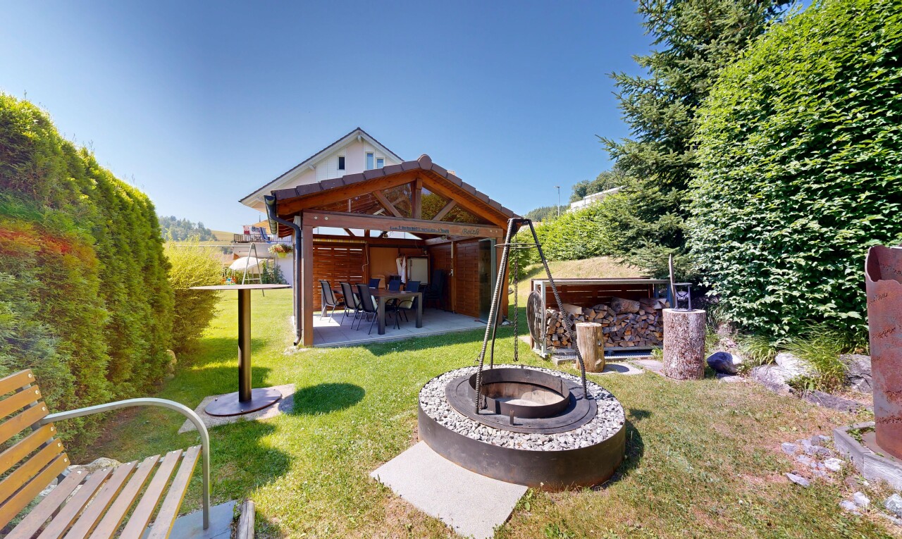 outdoor house with a patio area, an outdoor fire pit, and a yard