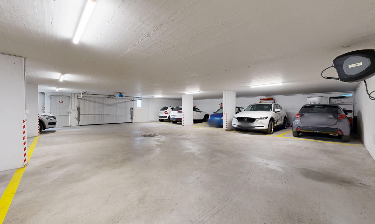 view of parking with a parking deck
