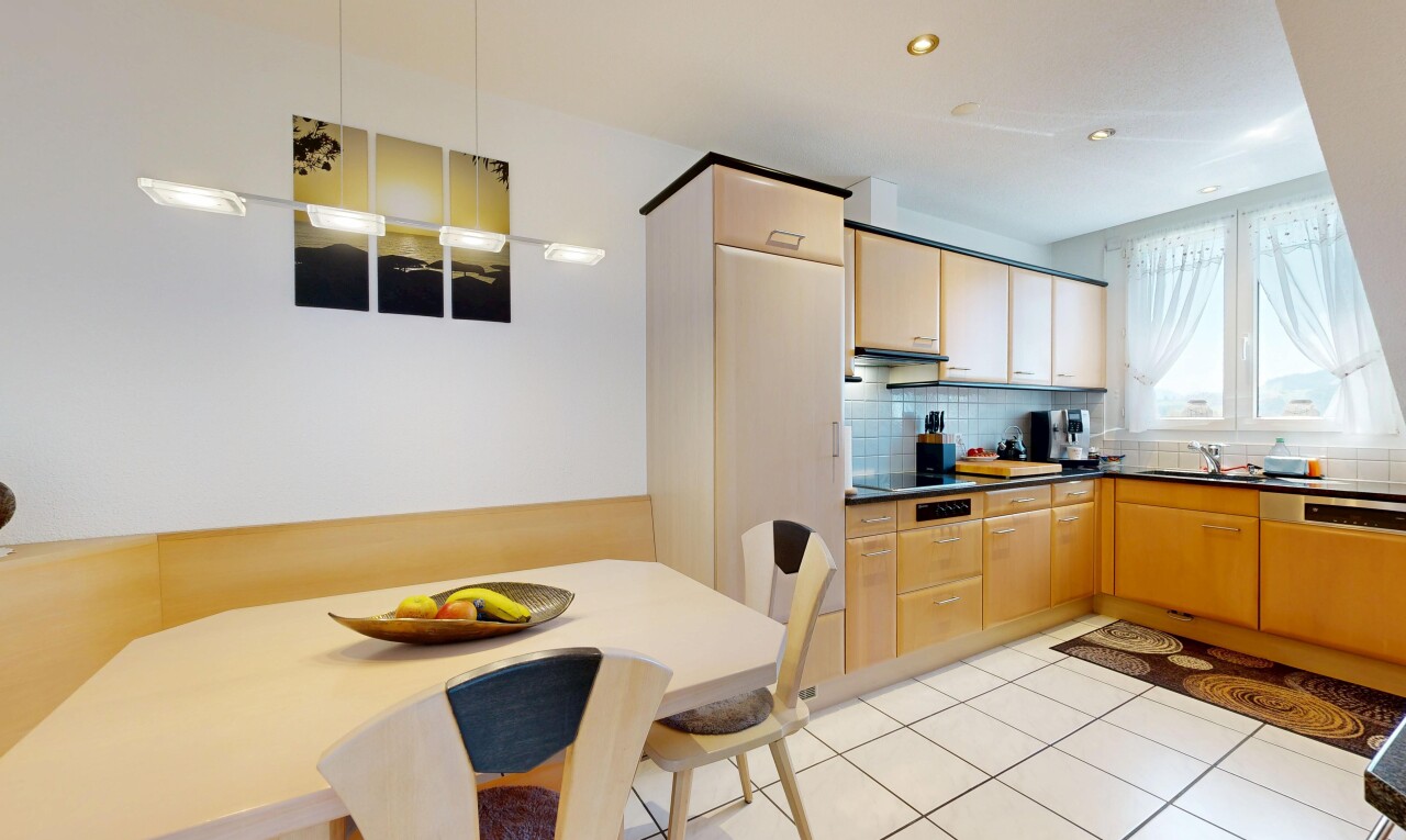 kitchen featuring dark countertops, recessed lighting, light tile patterned floors, backsplash, and light wood finish cabinets