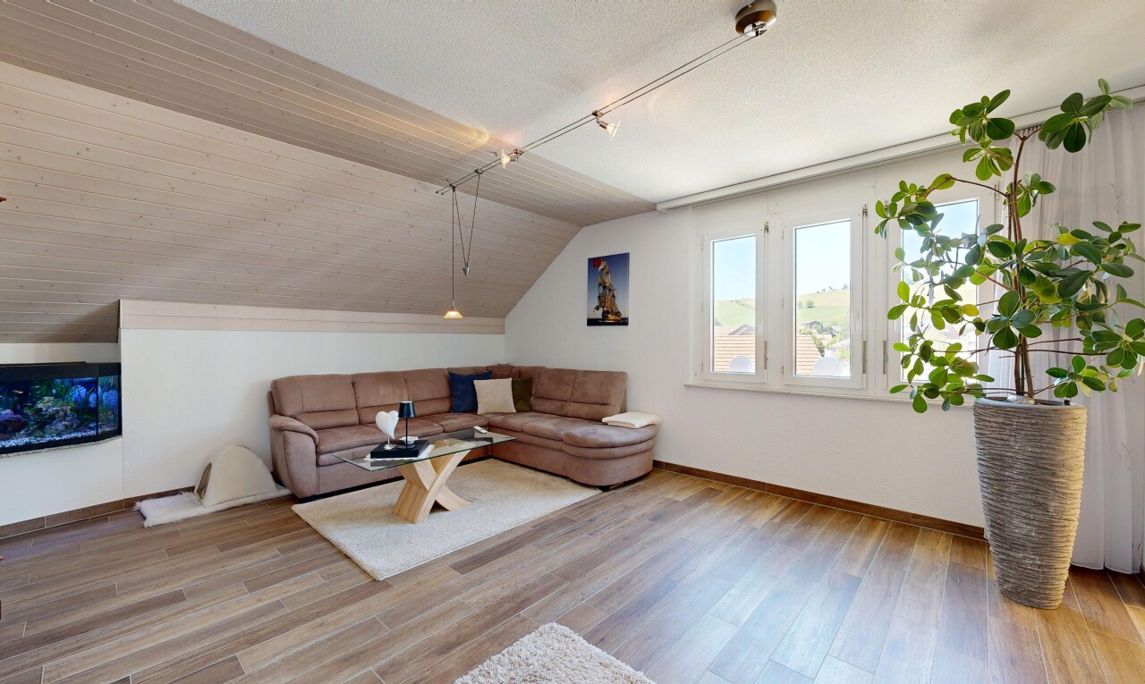 living area featuring vaulted ceiling and light wood finished floors