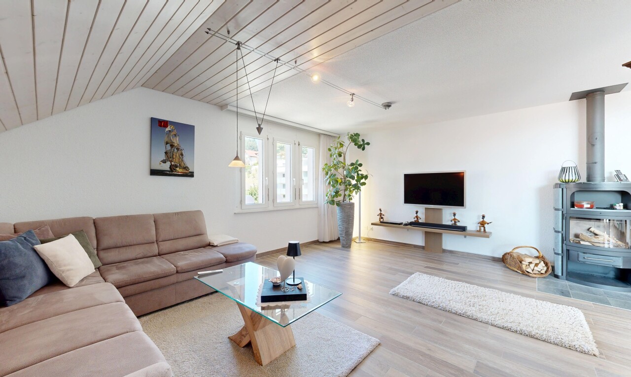 living room with rail lighting and light wood finished floors