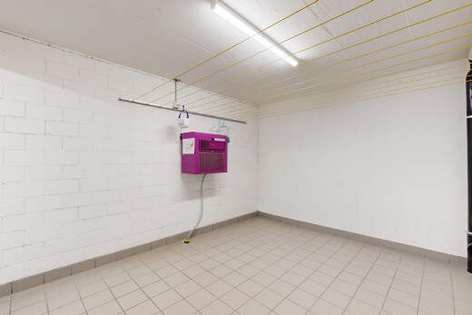 empty room featuring concrete block wall and light tile patterned flooring