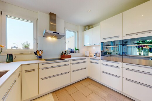 küche mit dunstabzugshaube, flat panel cabinets, schränke mit flachen paneelen, light countertops, und arbeitsplatten