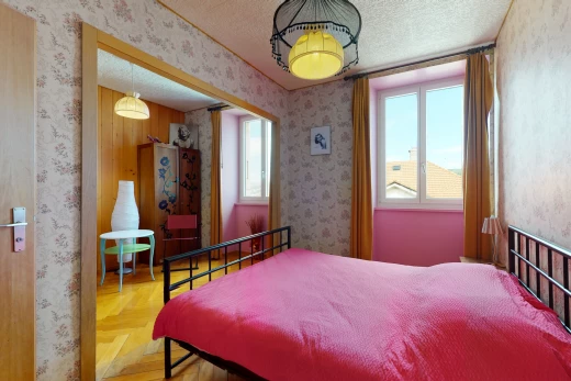 bedroom with natural light and hardwood floors