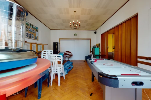 playroom with a chandelier and hardwood flooring