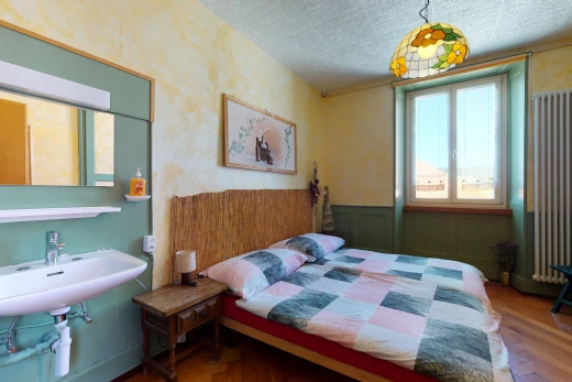 bedroom with natural light and hardwood flooring
