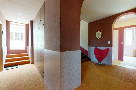 corridor with carpet and natural light
