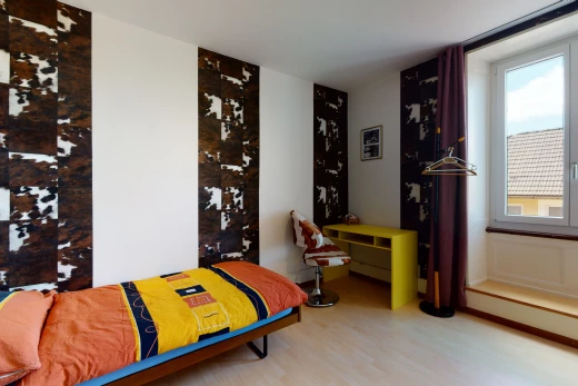 hardwood floored bedroom with natural light