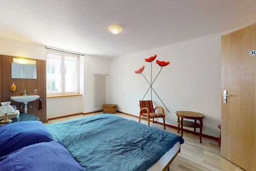 hardwood floored bedroom with natural light