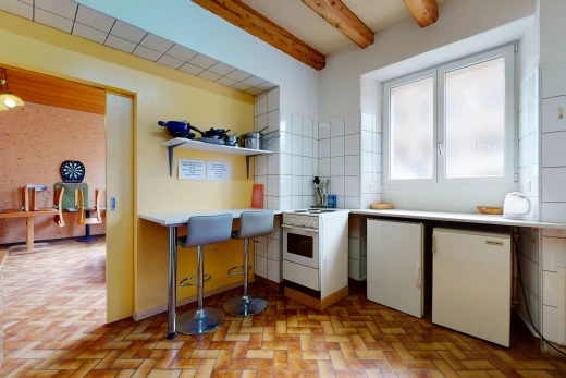 kitchen featuring wood beam ceiling, light tile floors, and light countertops