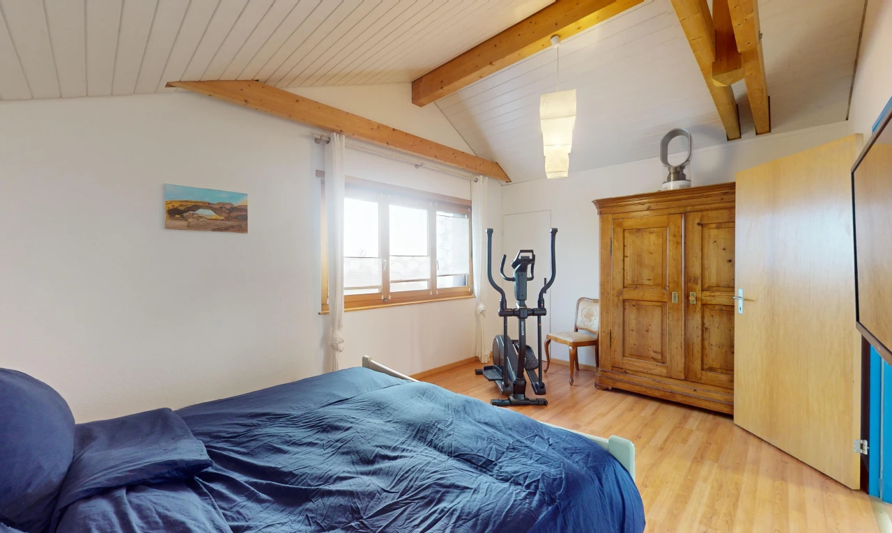 room / bedroom featuring hardwood / wood-style flooring and lofted ceiling with beams