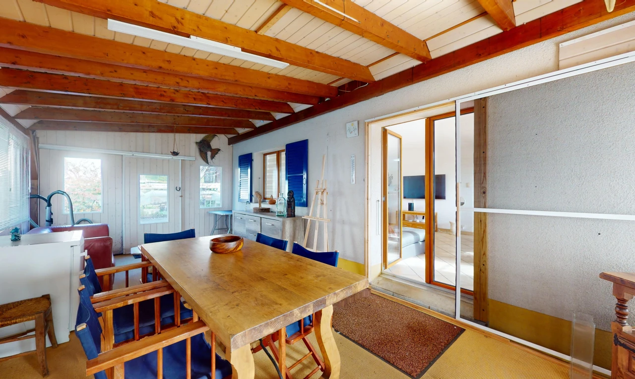 dining room with vaulted ceiling with beams