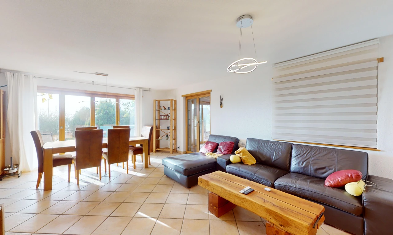 living / dining room featuring an inviting chandelier and light tile patterned flooring