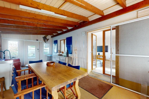 dining room with vaulted ceiling with beams