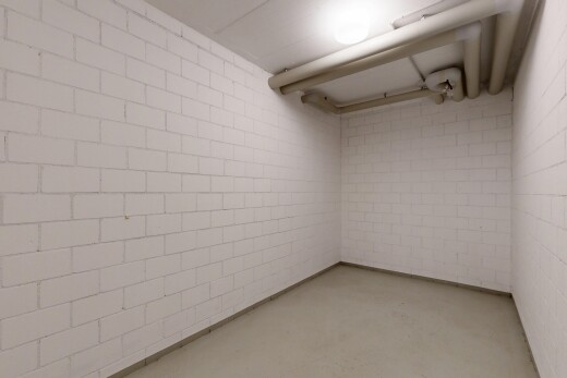 unfurnished room featuring concrete flooring and concrete block wall