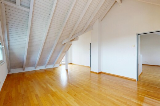 empty room featuring light wood-type flooring and a high wooden beamed ceiling
