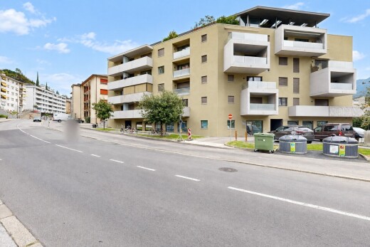 view of apartment building / complex featuring curbs