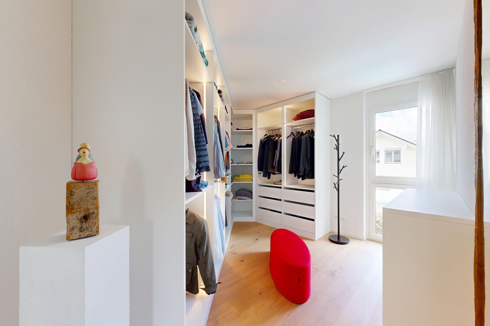 walk in closet with light wood-style flooring