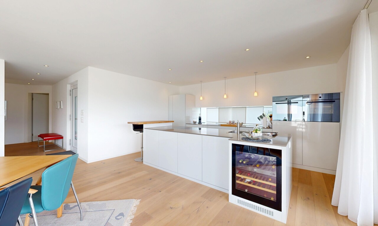 kitchen featuring modern cabinets, light wood-style floors, white cabinetry, and decorative light fixtures