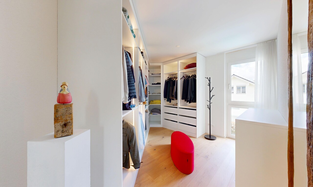 walk in closet with light wood-style flooring