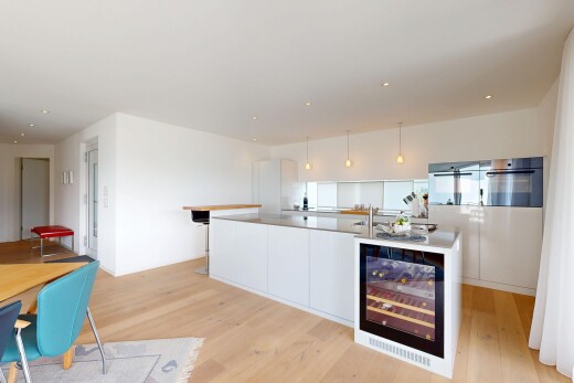 kitchen featuring modern cabinets, light wood-style floors, white cabinetry, and decorative light fixtures