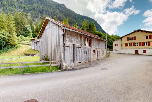 view of property featuring a barn, an outbuilding, and a mountain view