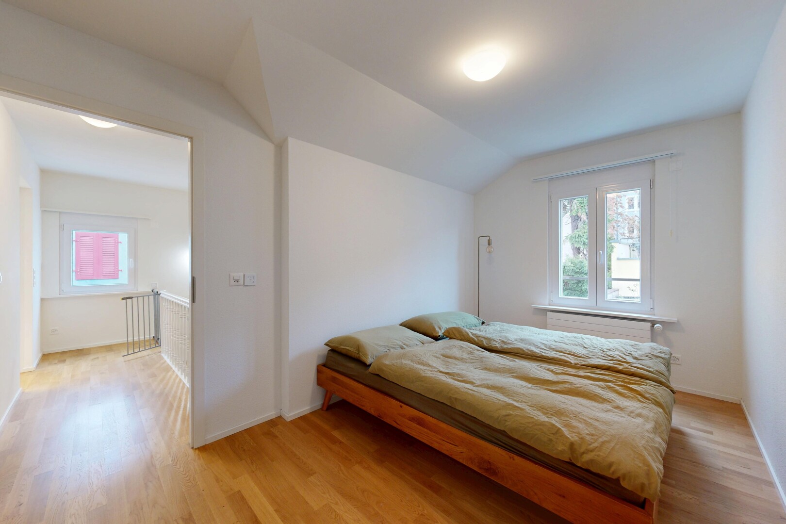 room / bedroom with light wood-style floors, vaulted ceiling, and multiple windows