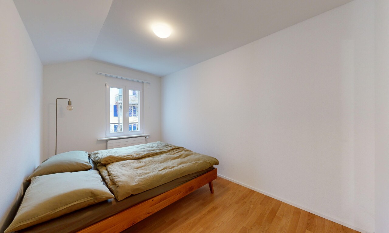 room / bedroom with vaulted ceiling and wood finished floors