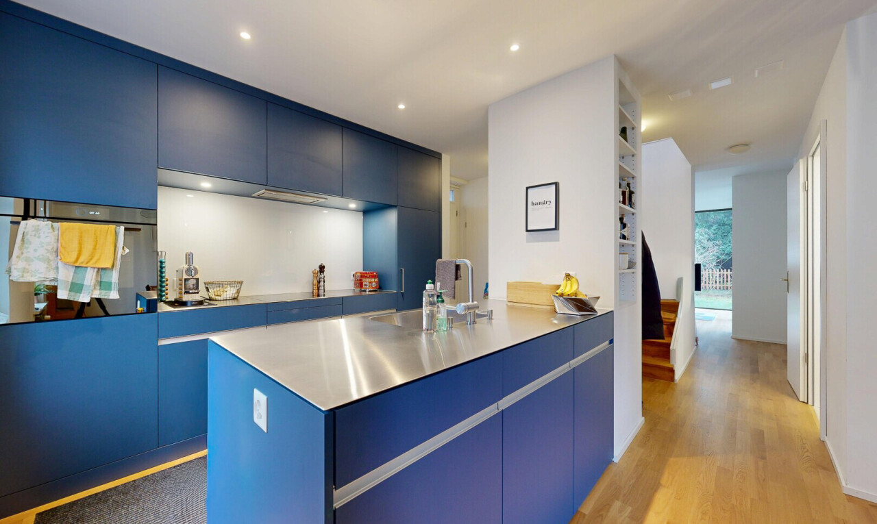 kitchen featuring modern cabinets, blue cabinets, dark wood-style flooring, oven, and recessed lighting