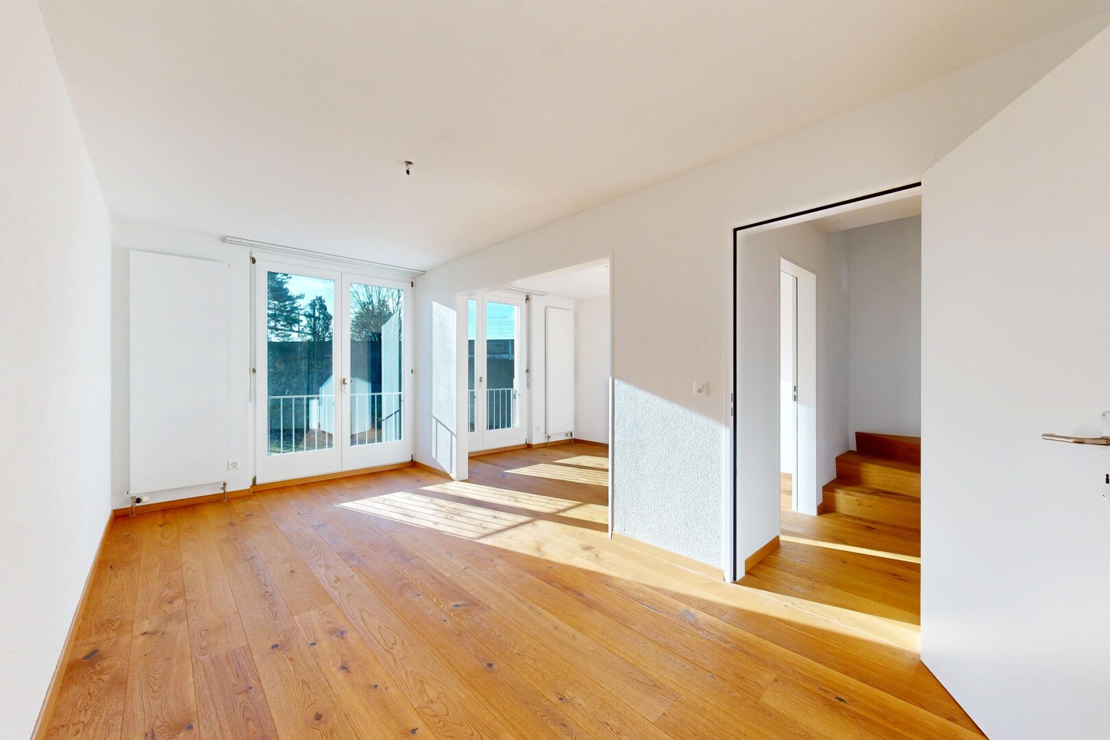 empty room featuring light wood-style floors and stairway