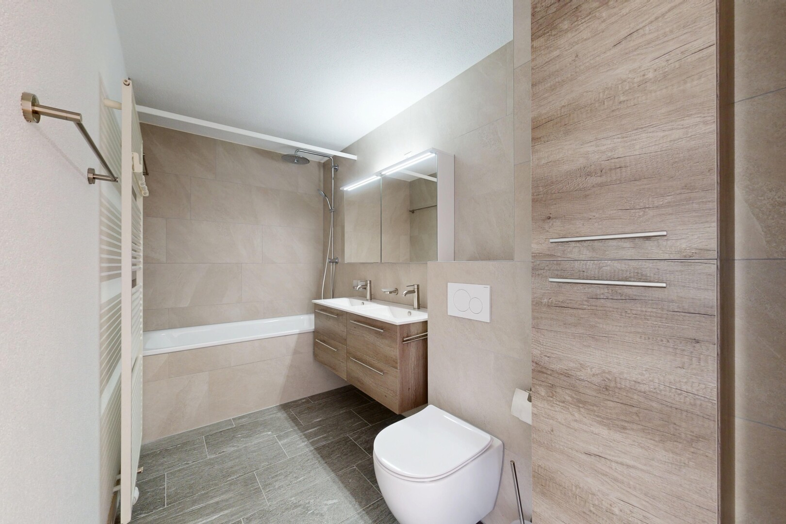 bathroom featuring tiled shower / bath combo, vanity, tile walls, and light tile patterned floors