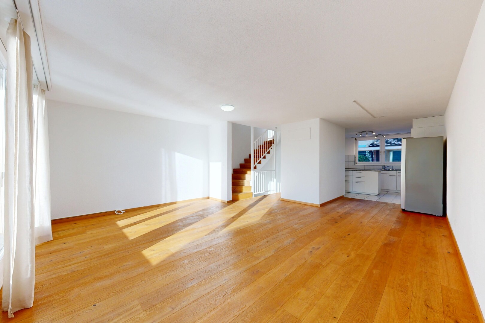 unfurnished room with stairs and light wood-style floors