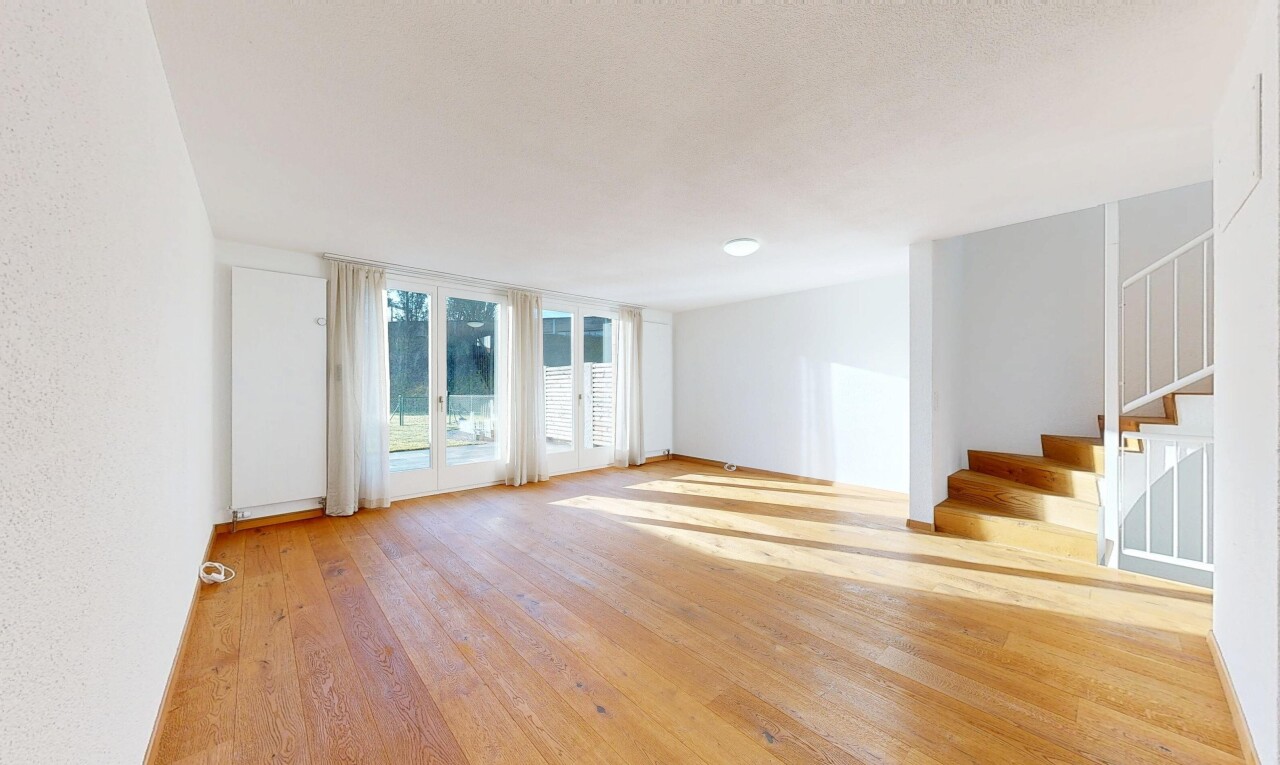 empty room with light wood-style floors and stairs
