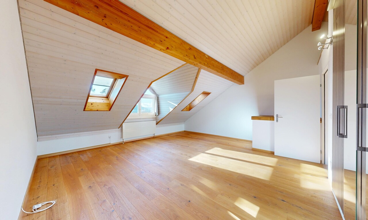 unfurnished room featuring lofted ceiling with beams, light wood-style flooring, and a skylight