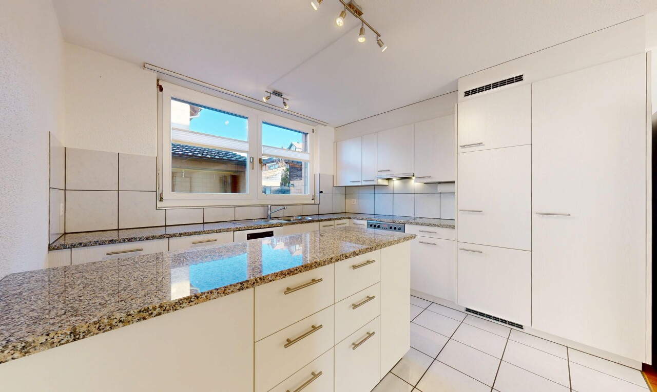 kitchen with modern cabinets, light stone countertops, track lighting, white cabinets, and light tile patterned floors