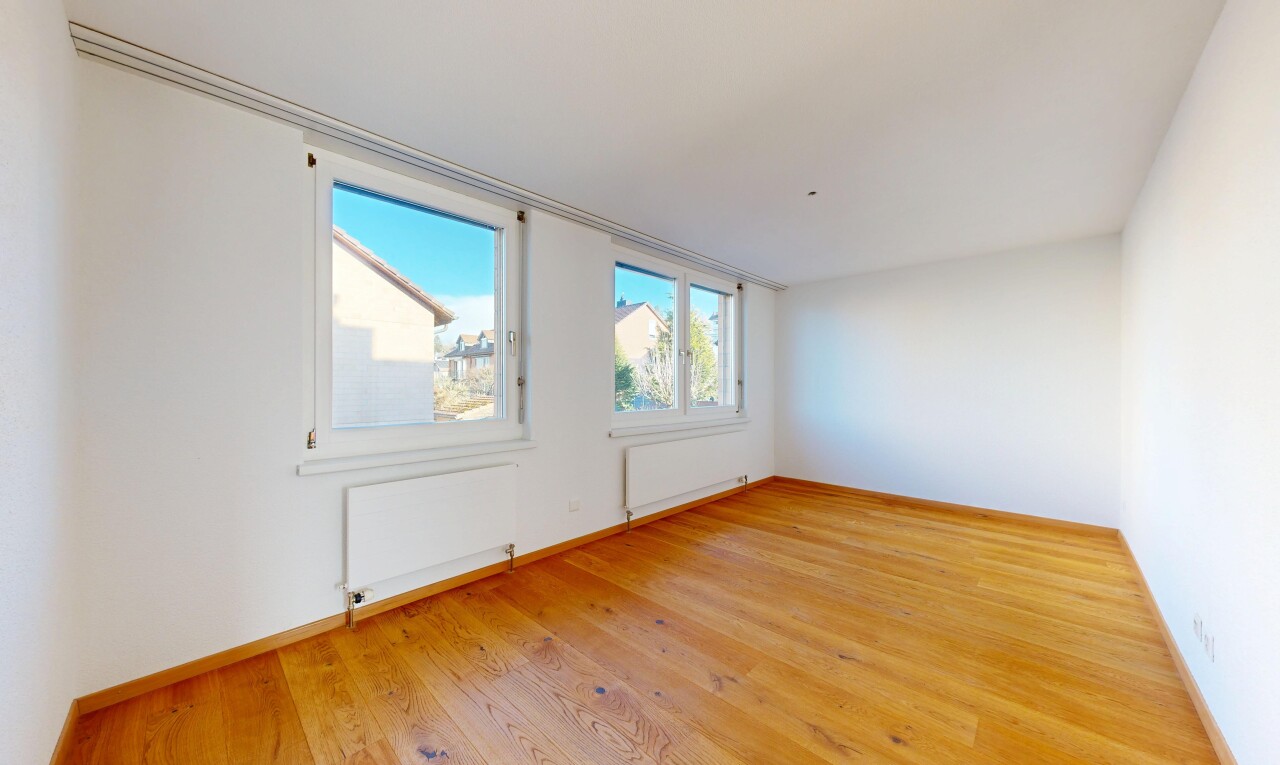 spare room with light wood-style floors, radiator heating unit, and plenty of natural light